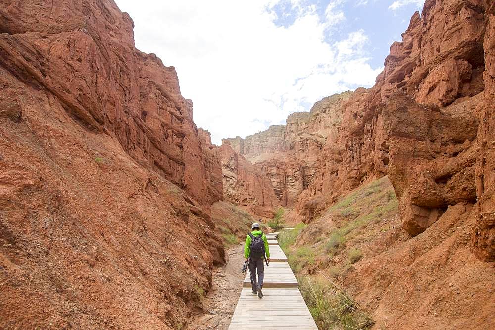 Tourist in Eroded hills of sedimentary conglomerate and sandstone, Unesco World Heritage, Zhangye, China