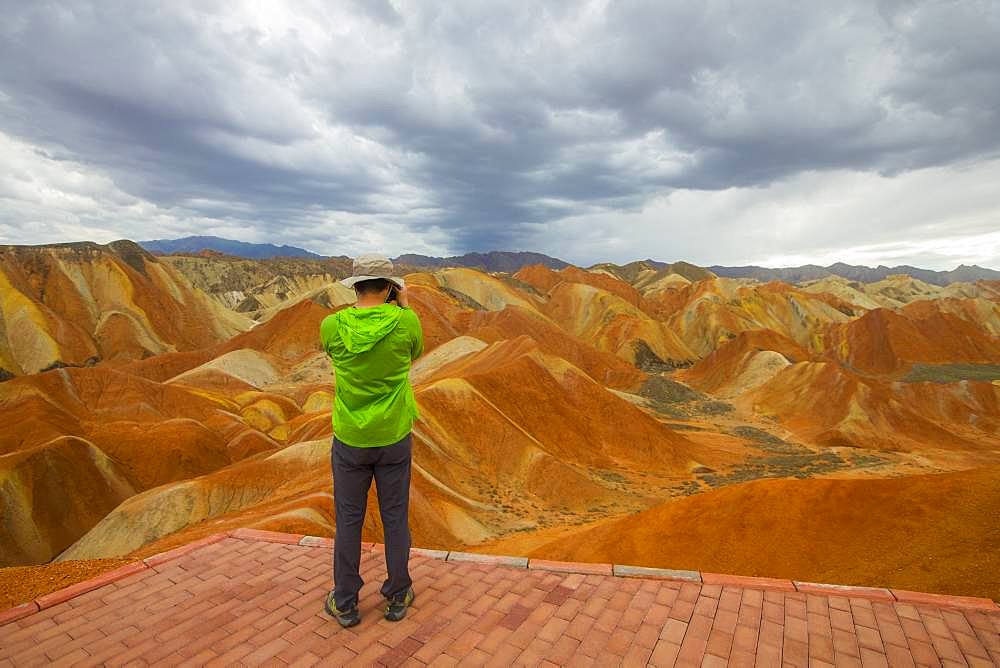 Tourist photograph, Eroded hills of sedimentary conglomerate and sandstone, Unesco World Heritage, Zhangye, China