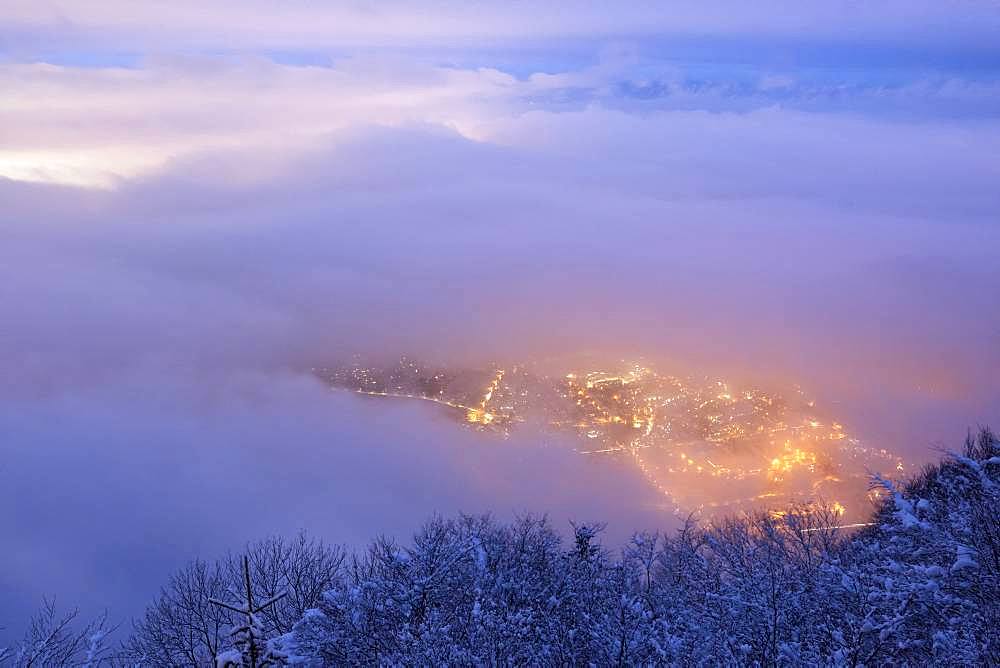 Stratus on the Geneva basin at dusk. Lights of Collonges-sous-Saleve seen from Mont Saleve, Haute-Savoie, Alps, France