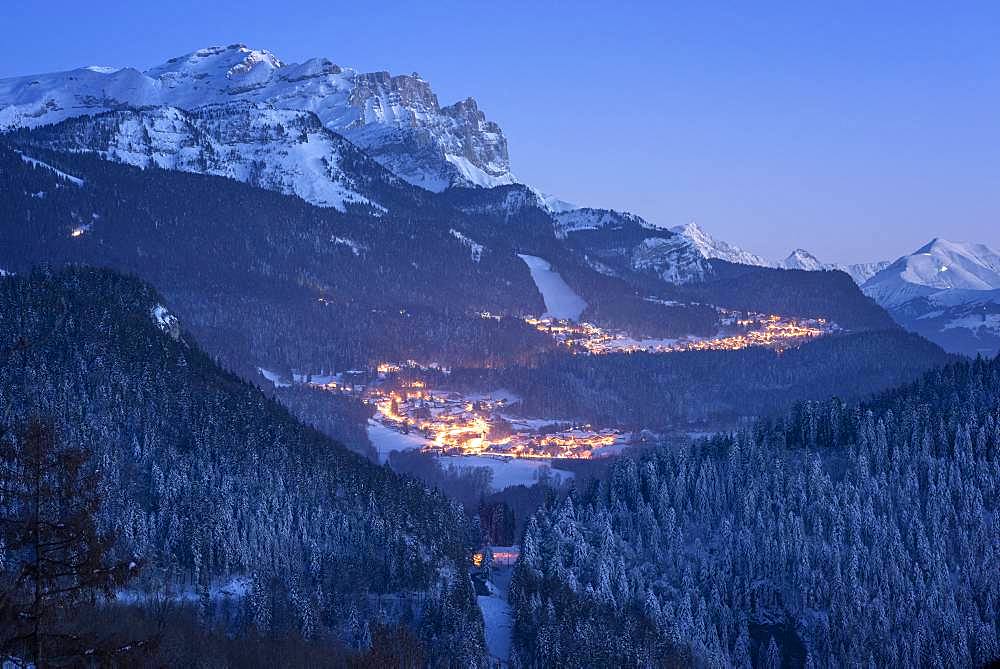 Ski resort Les Carroz, at dusk, and massif of Faucigny, Haute-Savoie, Alps, France