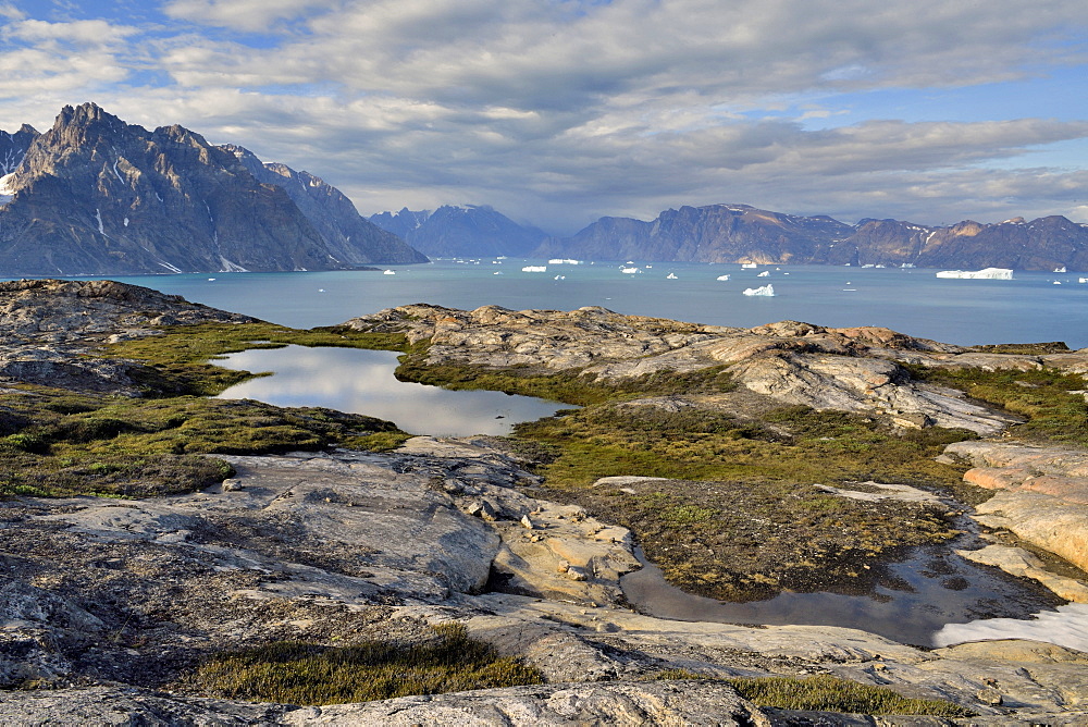 Landscape of the Bredning Hall at the bottom of Scoresby Sund, from one of the islands of the Bear Archipelago, to the bottom of the great basalt cliffs of Greenland