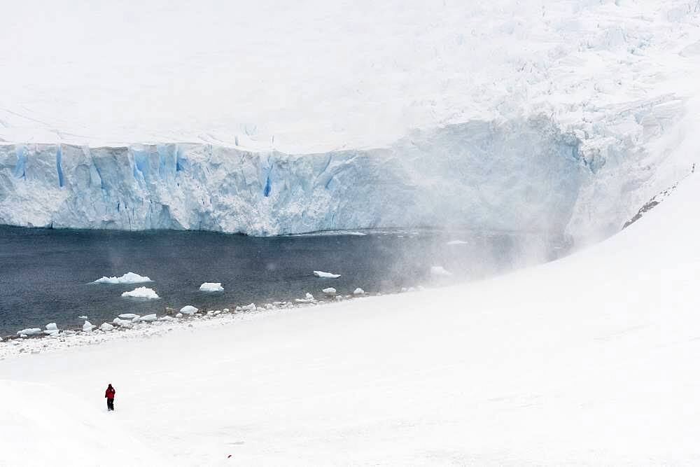 A tourist hiking in Neko Harbour, Antarctica.