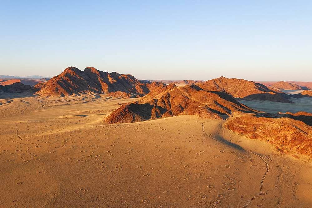 Fairy circles and mountains, Aerial view, Namib Naukluft Park, Namib Desert, Namibia.