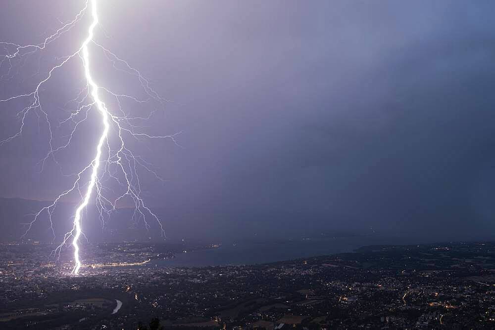 Lightning strike in Geneva during the storm on July 25, 2019. Shooting from Mont Sal?ve, 1000m above Geneva. Haute-Savoie, France