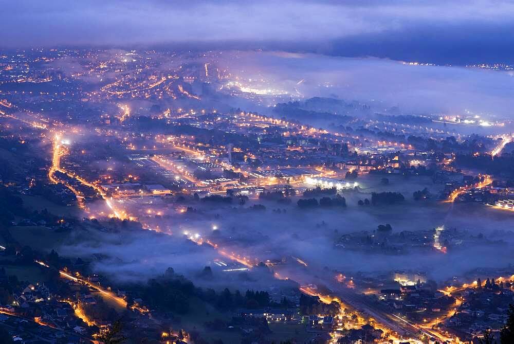 Fog at dusk in the morning over the Arve valley. Air and light pollution in the Arve valley. Shooting from Mont M?le, Haute-Savoie, France