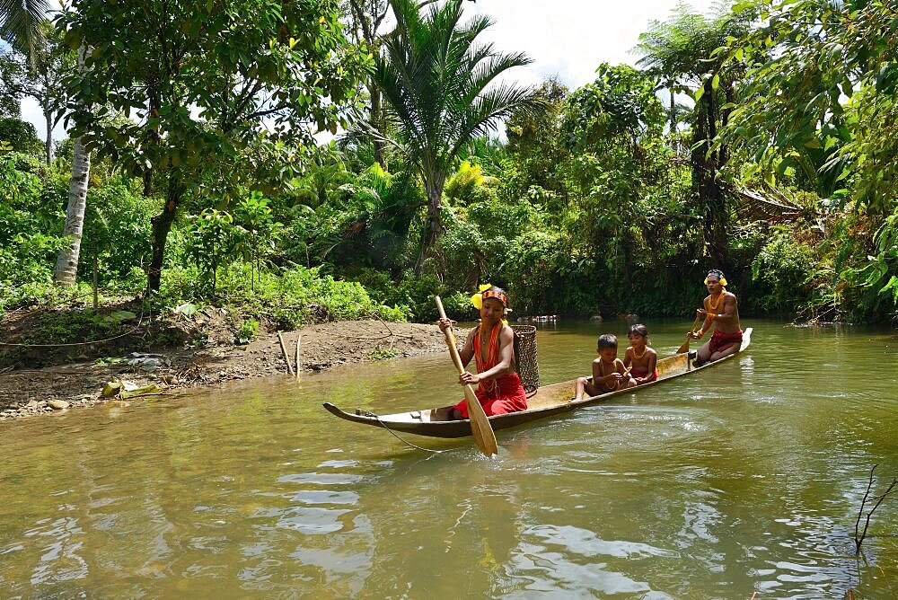 Mentawai familly on dugout, Siberut, Indonesia