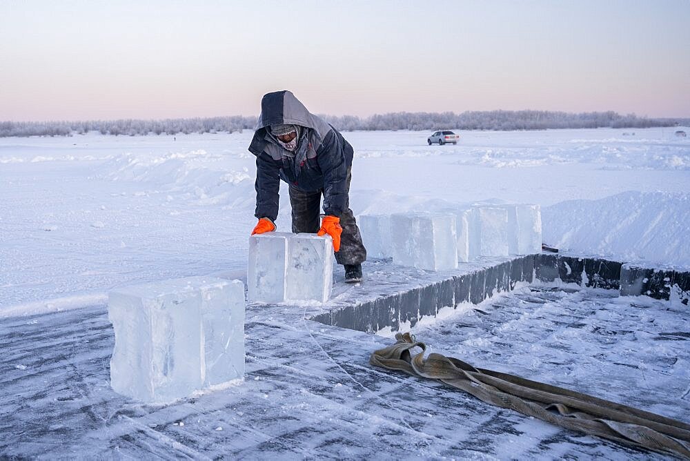 Extraction of ice cube from the Lena river for use as drinking water by residents without access to running water, Yakutsk, Republic of Sakha, Russia