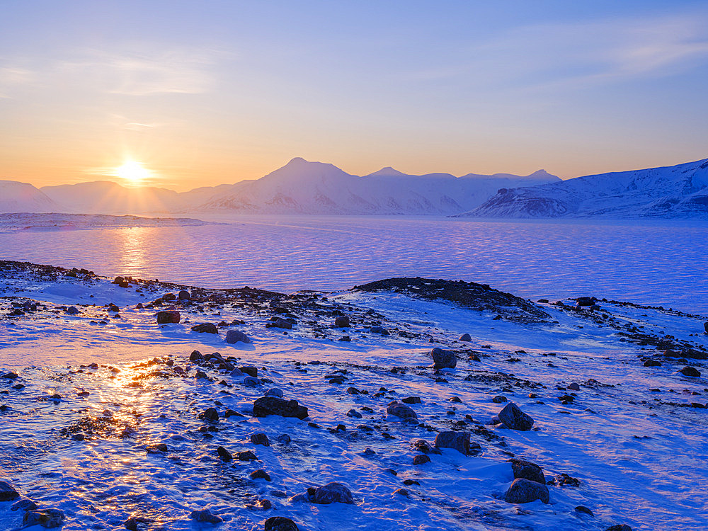 View over frozen Adolfbukta and Billefjorden near Nordenskioeldbreen towards Pyramiden ghost town. Winter landscape on the island Spitsbergen in the Svalbard archipelago. Arctic, Europe, Scandinavia, Norway, Svalbard