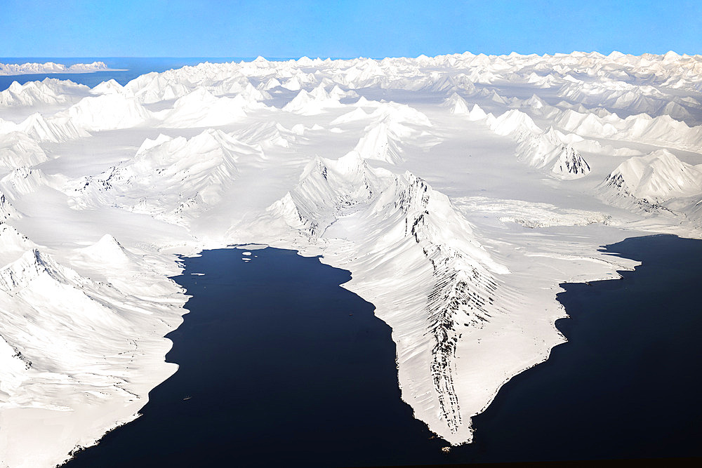 Aerial view over the snow-covered peaks of Svalbard. pointed peak known as spitzberg. latitude from 75 to 80 degrees, down to the pack ice near the north pole.