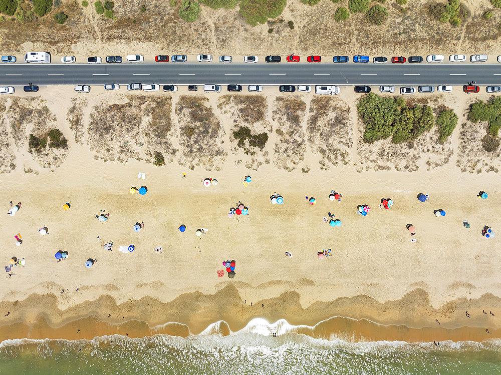 Beach life at the Atlantic Ocean near Punta Umbria. Aerial view. Drone shot. Huelva province, Andalusia, Spain.