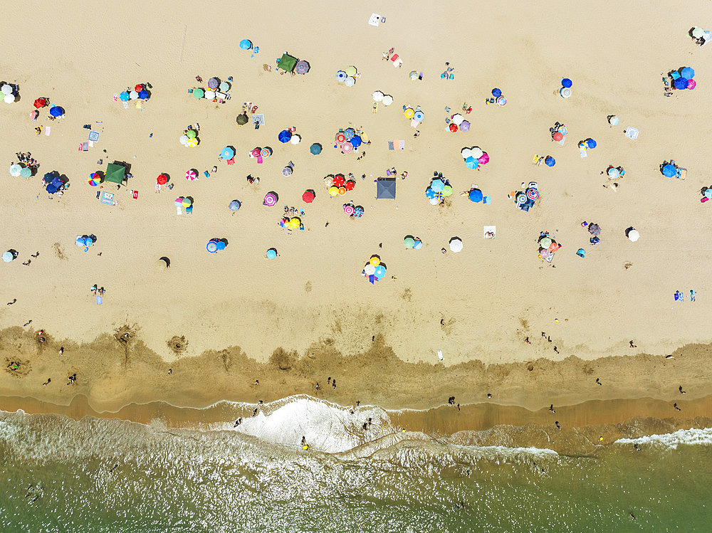 Beach life at the Atlantic Ocean near Punta Umbria. Aerial view. Drone shot. Huelva province, Andalusia, Spain.