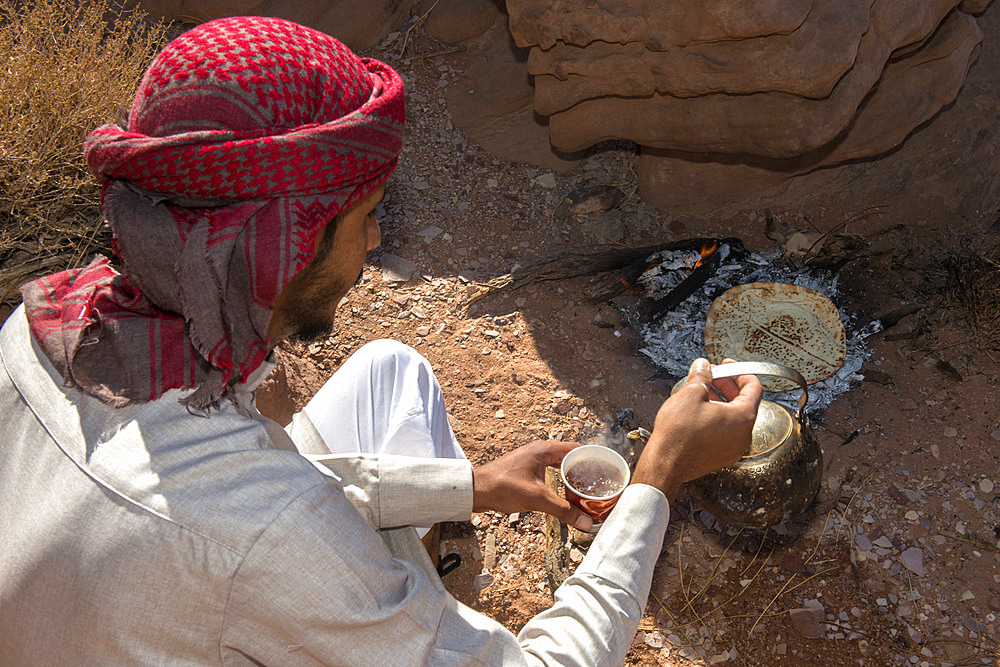 Bedouin preparing tea and cooking bread in a traditional way. Wadi Rum Desert;Uadi Rum). World Heritage Site since 2011;Unesco). Jordan.