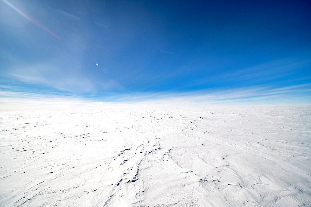 Frozen ground of Dome C, and sastrugis. Sastrugis are wind-blown snow formations. The wind is not extremely strong in these high-altitude locations. Concordia Station, Antarctic