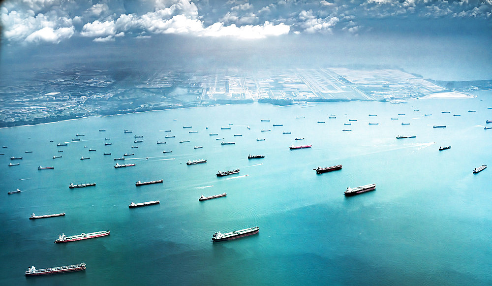 Congestion of waiting transport ships off the coast of Singapore, during the post-covid international shipping crisis.