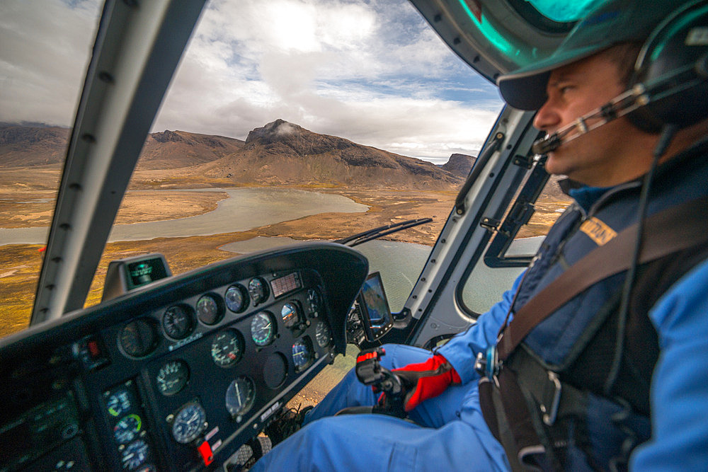The experienced helicopter pilot navigates by sight and close to the ground to get his bearings. Kerguelen Archipelago