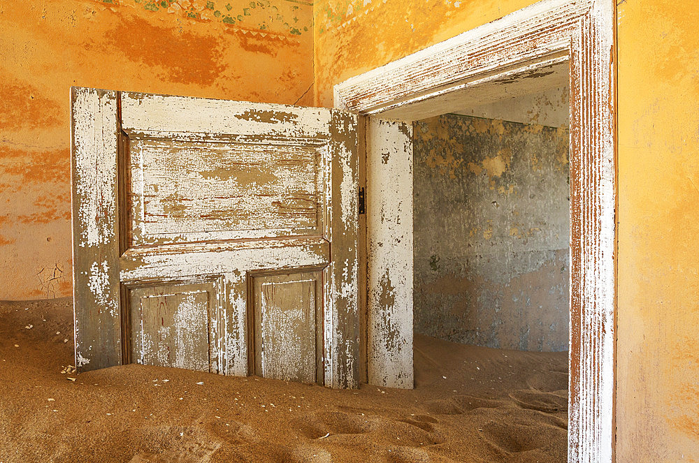 At Kolmanskop, the abandoned ghost town of the diamond days of the early 1900 and of German origin. Inside the restricted Diamond Area east of the coastal town of Luederitz. Namib Desert, Namibia.