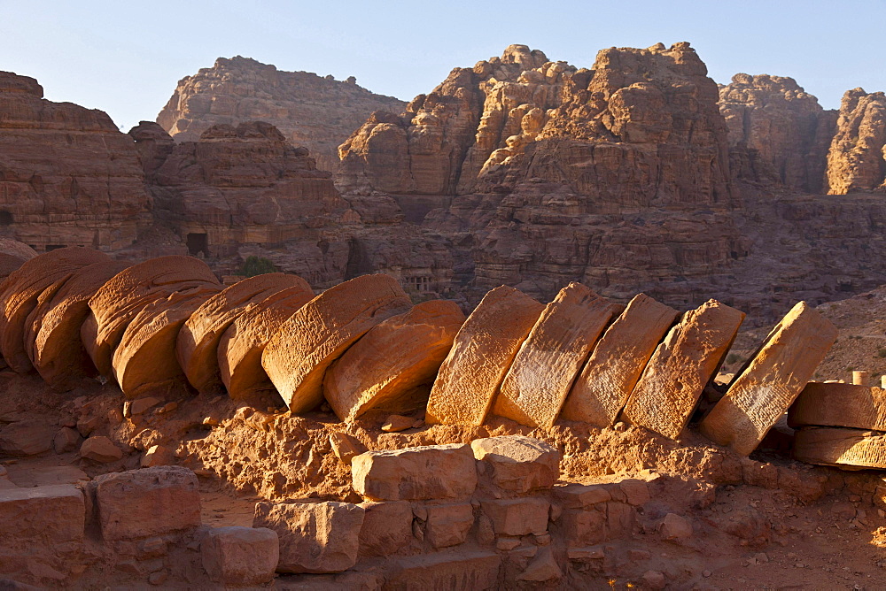 fallen fragmented pillar in old antique Greek temple remnants near city of Petra built into rocks outdoors Jordanian desert Jordan Asia