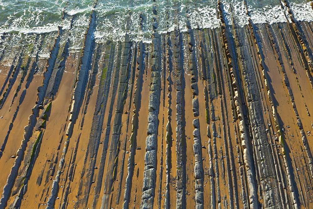 parallel rock formations on sea shore in tidal zone of sea top view outdoors La Rasa Mareal flysch cliffs Basque Country Spain Europe