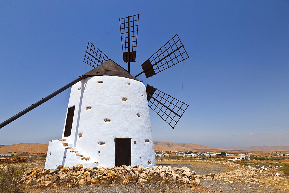 white solid stone mill windmill Pueblo Los Llanos de la Concepcion with six wings without fabric cover seen against blue cloudless sky outdoors calendar motif Fuerteventura Island Province Las Palmas Canary Islands Spain Europe 