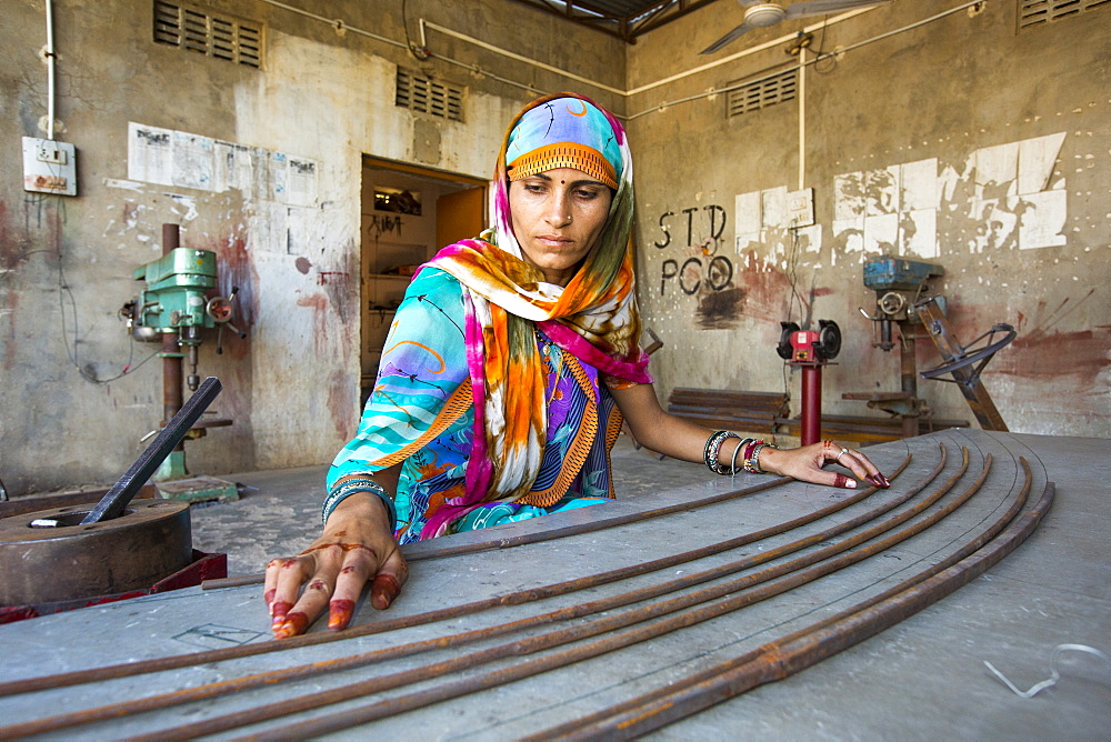 Women constructing solar cookers at the Barefoot College in Tilonia, Rajasthan, India. The Barefoot College is a worldwide charity, founded by Bunker Roy, its aims are, education, drinking water, electrification through solar power, skill development, health, women empowerment and the upliftment of rural people. The use of the cookers, vastly reduces the amount of fire wood women have to go out and collect from the forest.