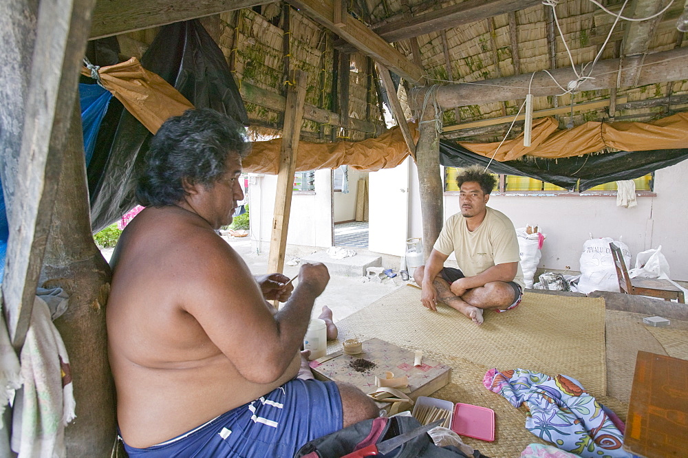 A Tuvaluan man making home made cigarettes on Funafuti Atoll, Tuvalu, Pacific