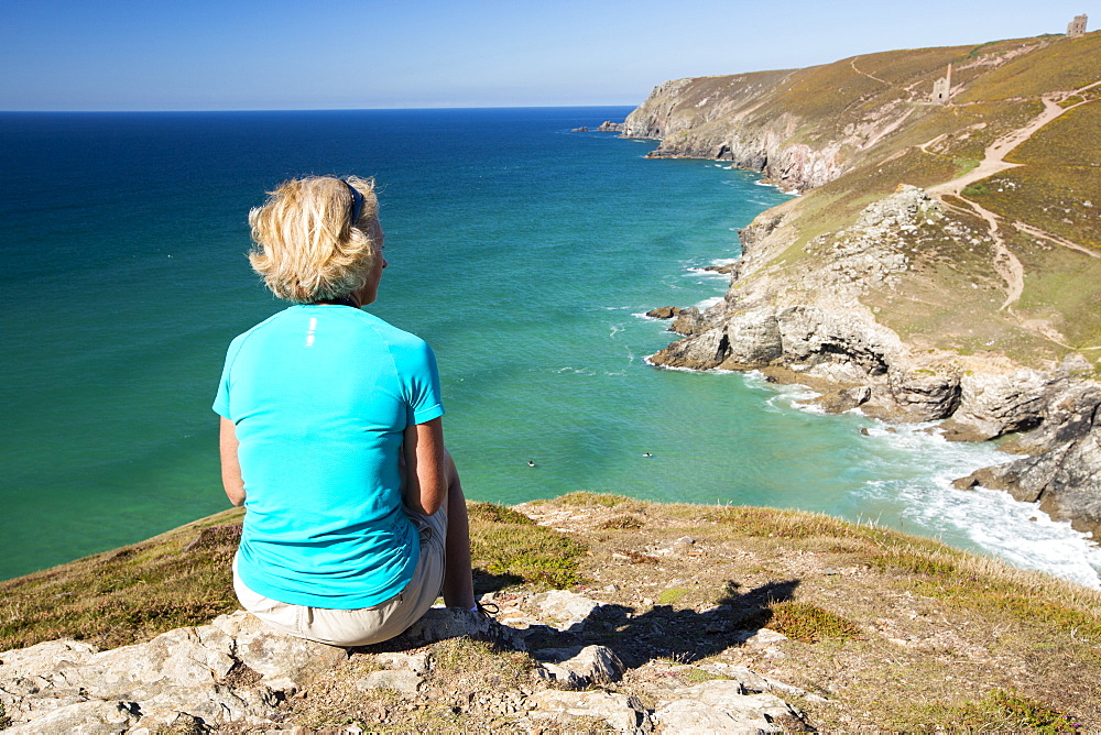 A woman above Chapel Porth on the Cornish coast, near St Agnes.