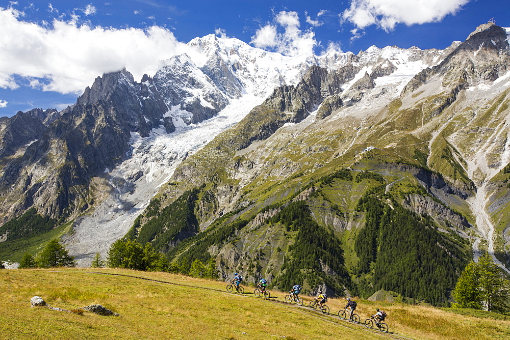 The rapidly receding Brenva Glacier in the Mont Blanc range, Italy, with cyclists