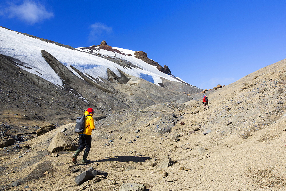 Passengers on an expedition cruise climbing the caldera on Deception Island in the South Shetland Islands off the Antarctic Peninsular which is an active volcanic.