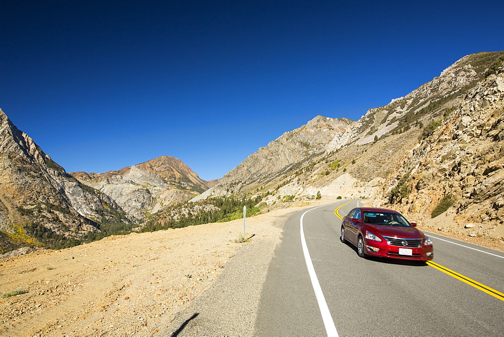 A car travelling from Lee Vining into Yosemite National Park, California, USA.