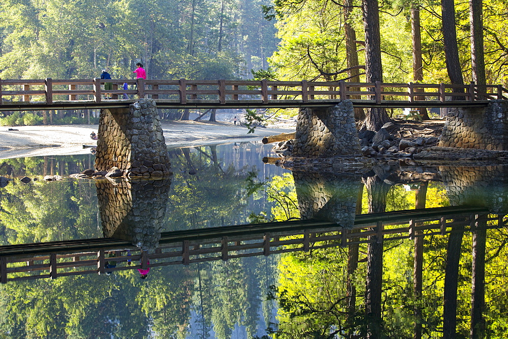 Reflections and a bridge crossing the Merced River, Yosemite Valley, Yosemite National Park, California, USA.