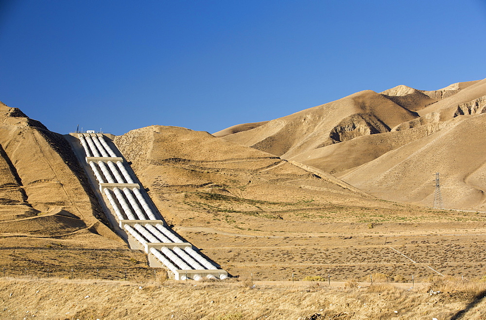 A pumping station sends water uphill over the mountains on the California aquaduct that brings water from snowmelt in the Sierra Nevada mountains to farmland in the Central Valley. Following a four year long catastrophic drought, irrigation water is in short supply, with $2 billion annually wiped off the agricultre sector.