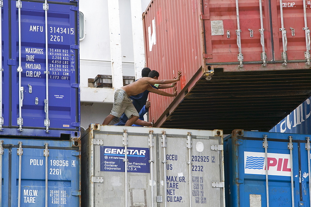 Tuvaluan workers loading containers on the supply ship for Funafuti Atoll, Tuvalu, Pacific