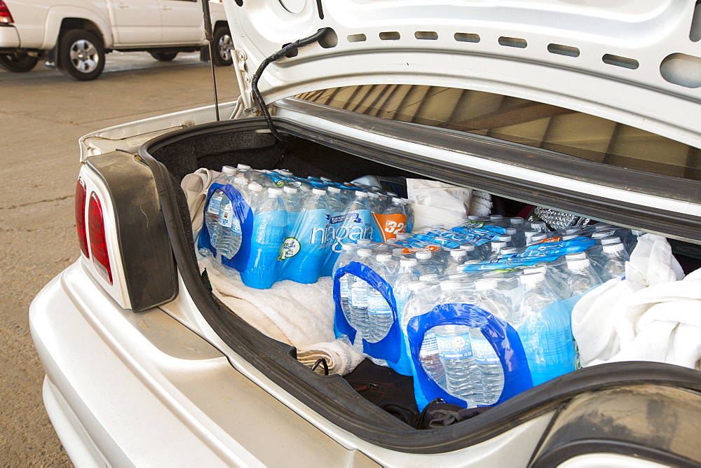 A water charity in Porterville supplying bottled water to houses who have had no running water for over five months, near Bakersfield, California, USA. Hoses in the East of Porterville, many of which are on private wells, have run completely out of water as the water table has dropped catastrophically. Following an unprecedented four year long drought, Bakersfield is now the driest city in the USA. Most of California is in exceptional drought, the highest level of drought classification. 428,000 acres of agricultural land have been taken out of production due to lack of water, thousands of agricultural workers have lost their jobs and one third of all children in California go to bed hungry.