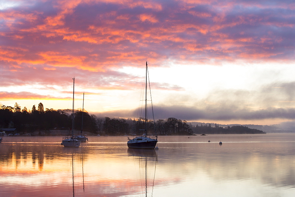 Sunrise over sailing boats on Lake Windermere in Ambleside, Lake District, UK.