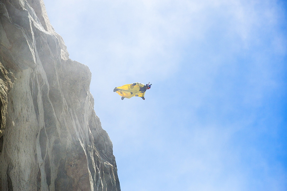 A base jumper wearing a wing suite jumps from the Aiguille Du Midi above Chamonix, France.