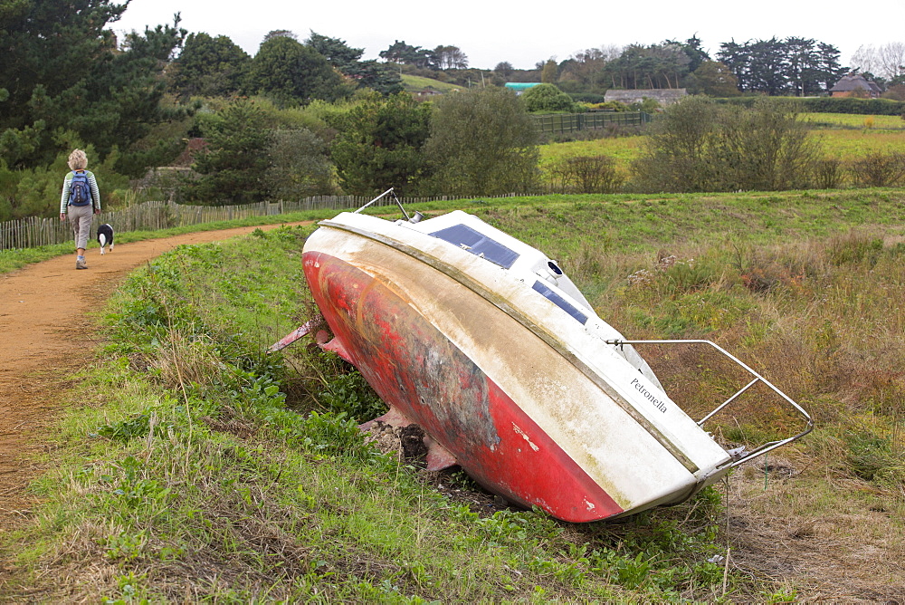 A boat ripped off oits moorings and damaged by the extreme storm surge weather in December 2013 in Blakeney on the North Norfolk coast, UK.