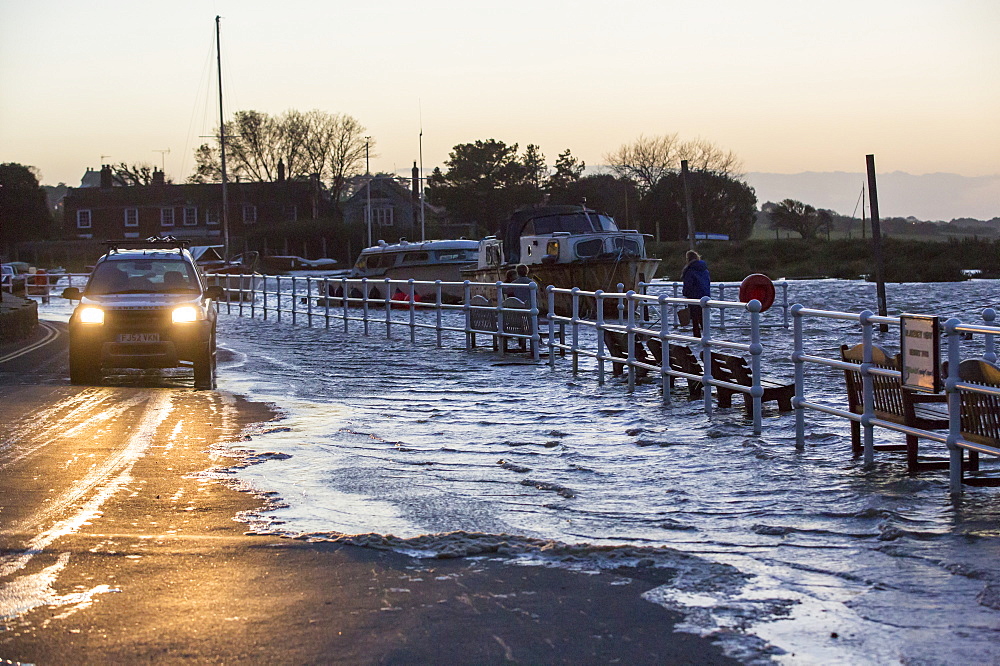 A high tide pushed by gale force winds flooding the sea front in Blakeney, Norfolk, UK.