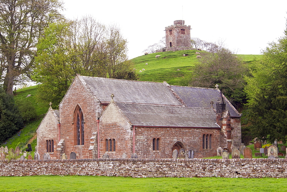 The Church and bell tower in Kirkoswold in the Eden Valley, Cumbria, UK. The church was built down in a dip, so they built the bell tower seperately on a hill top so that the bells could be heard, when they were sounded as a warning of the Scots invading.