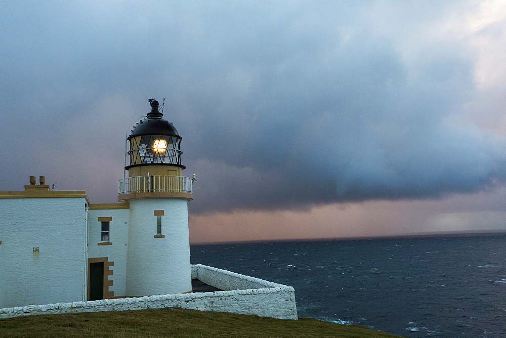 Rain showers at sunset over Stoer Ppoint lighthouse in assynt, north West Highlands, Scotland, UK.