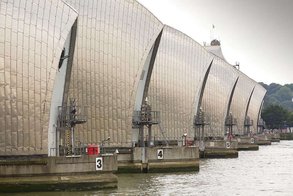 The Thames barrier on the River Thames in London. It was constructed to protect the capital city from storm surge flooding. Recent predictions show it will probably be redundant in around twenty years due to increased stormy weather and sea level rise driven by climate change.