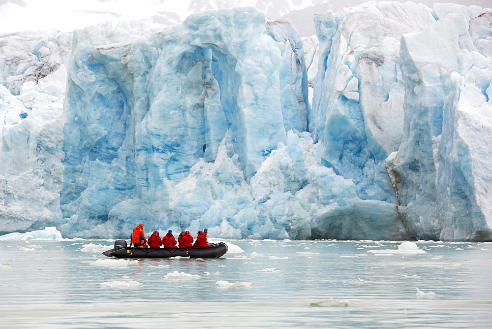 Passengers on Zodiaks off the Russian research vessel, AkademiK Sergey Vavilov an ice strengthened ship on an expedition cruise to Northern Svalbard in front of a glacier.