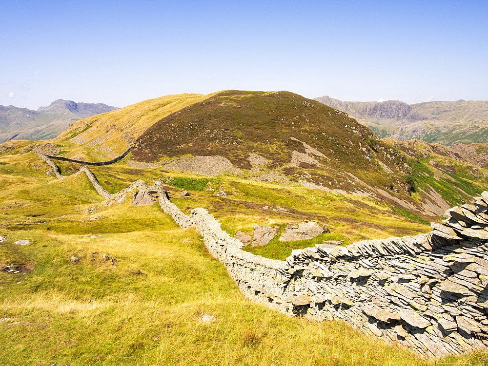 A dry stone wall on Lingmoor above Langdale valley in the Lake District, UK.