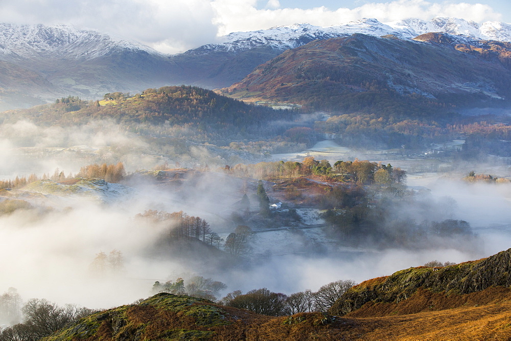 Looking down into the Langdale Valley above valley mist formed by a temperature inversion on Loughrigg, near Ambleside in the Lake District National Park.