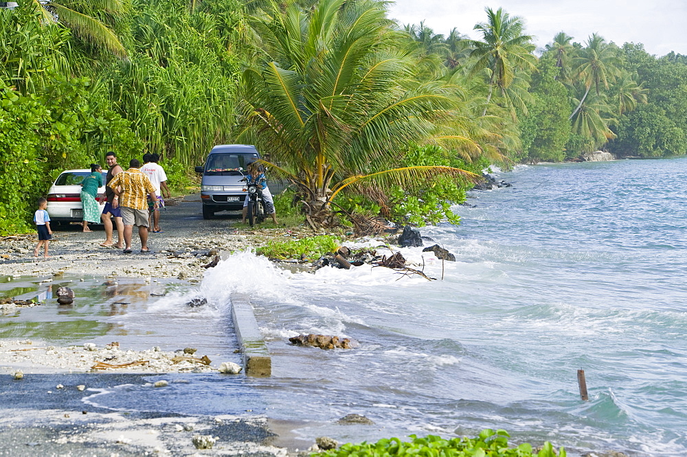 Tuvaluans watch as the high tide inundates their island home due to global warming induced sea level rise, Funafuti, Tuvalu, Pacific