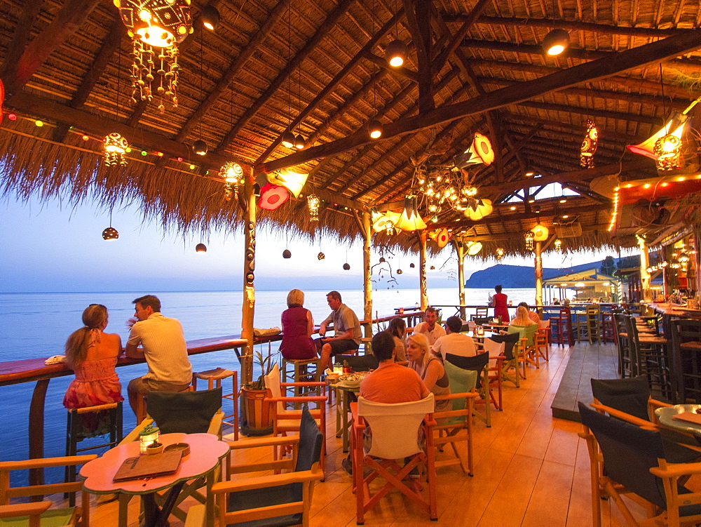 A seafront cocktail bar in Skala Eresou, Lesbos, Greece at sunset.