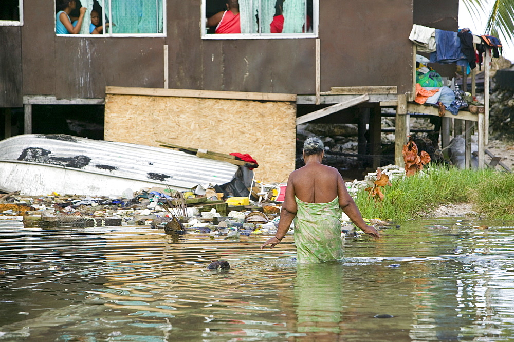 Houses flooded by sea water incursion due to global warming induced sea level rise that threatens the future of these low lying islands, Funafuti Atoll, Tuvalu, Pacific