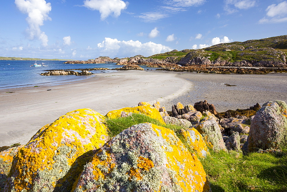 Lichen covered granite boulders at Fionnphort Isle of Mull, Scotland, UK, looking towards Iona.