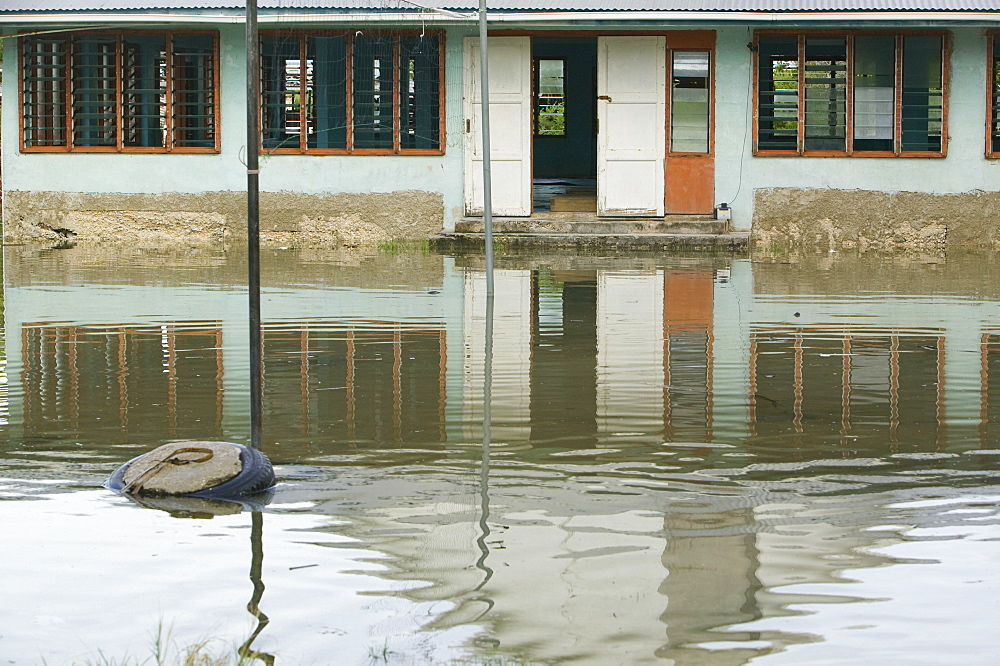 Houses flooded by sea water incursion due to global warming induced sea level rise that threatens the future of these low lying islands, Funafuti Atoll, Tuvalu, Pacific