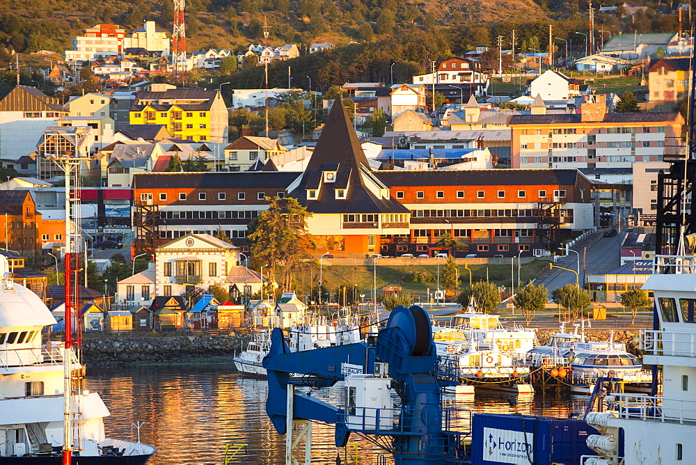 Sunrise over ships in the harbour of Ushuaia which is the capital of Tierra del Fuego, in Argentina, it is the most southerly city in the world and the starting point for trips to Antarctica.