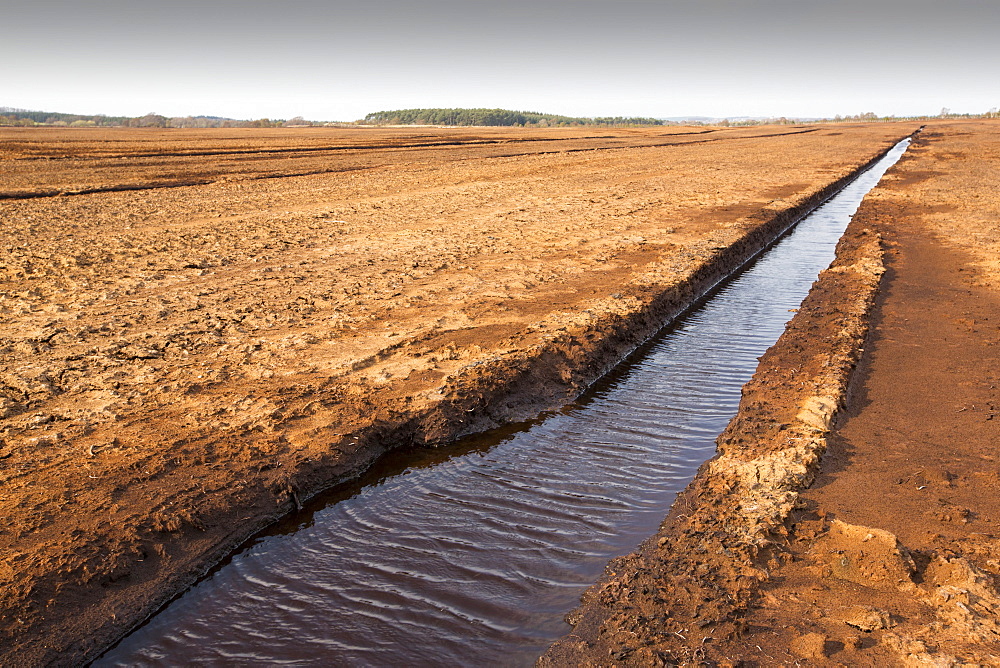 A raised bog being harvested for peat near Douglas water in the Southern Uplands of Scotland. Raised bogs re rare threatened habitats and important carbon sinks that should not be exploited.